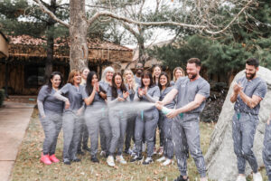 Team celebration with the doctors opening champagne outside