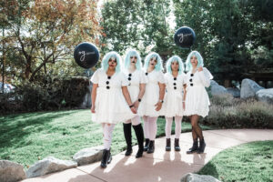 5 staff members dressed as clowns in the practice's brand colors